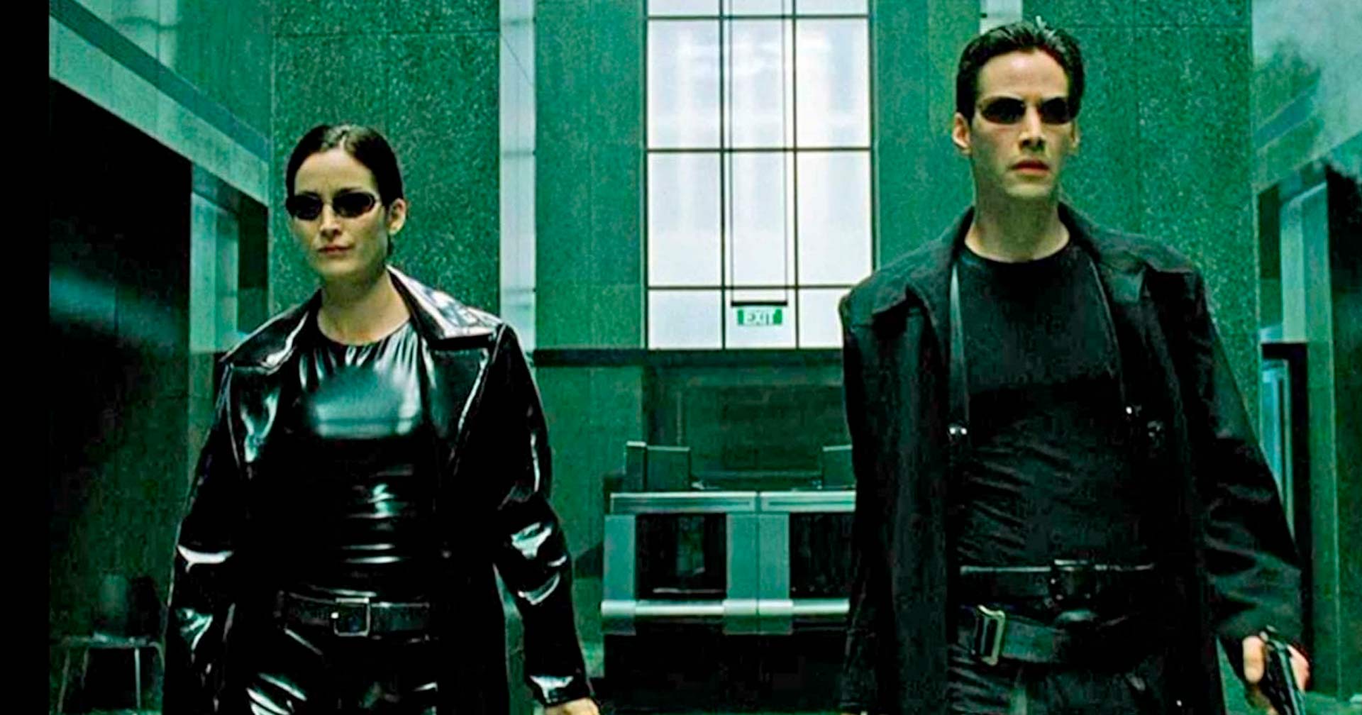 Dois personagens do filme Matrix, um ao lado do outro, os dois vestidos de preto, com óculos escuros e um fundo esverdeado, com traços horizontais e verticais guiando o olhar na imagem.